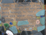 Mosaic on the bench under the canoe stand near Eastlake and Roanoke.